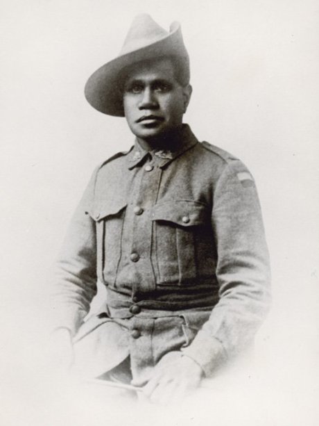 Seated man wearing a hat and military uniform